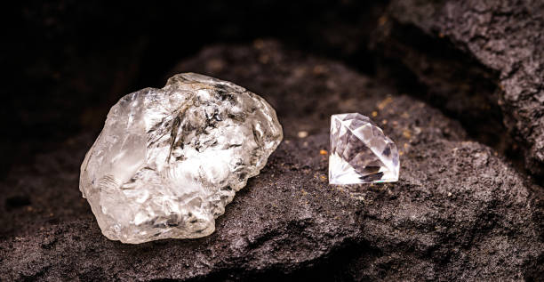 Comparison of uncut and processed diamonds. On the left, a raw diamond in its natural form. On the right, a cut and processed diamond, showcasing its exquisite brilliance. Set against a black rock background