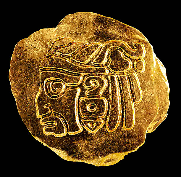A round, ancient gold artifact featuring the profile of a Mayan god, adorned with Native American features and intricate motifs